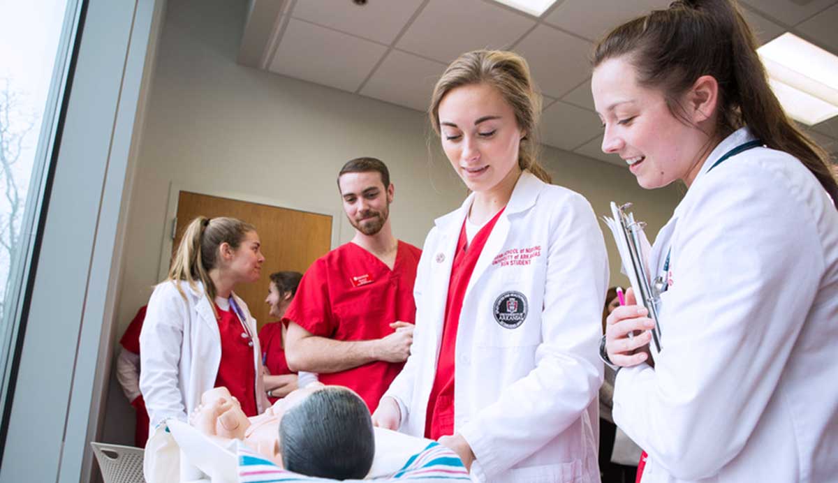 The Nursing Program Director with students in a lab.